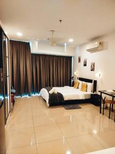 a bedroom with a bed and a large window at Cozy Haven Perfect Studio Getaway in Petaling Jaya