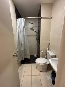 a small bathroom with a toilet and a sink at Cozy Haven Perfect Studio Getaway in Petaling Jaya +8 photos