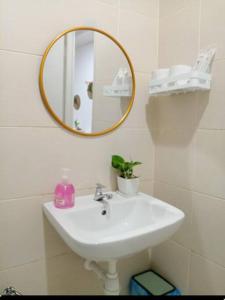 a bathroom with a white sink and a mirror at Cozy Haven Perfect Studio Getaway in Petaling Jaya