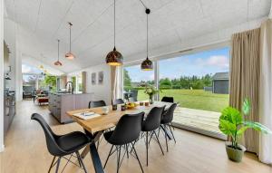 a dining room and kitchen with a table and chairs at 4 Bedroom Beautiful Home In Hemmet in Hemmet