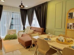 a living room with a table and a couch at Ekocheras @ Kuala Lumpur in Kuala Lumpur