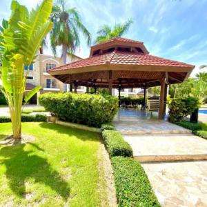 a gazebo in the backyard of a house at Apartamento en Punta Cana, White sands in Punta Cana +22 photos