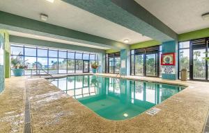 a swimming pool in a room with a large window at Meridian Plaza 404 in Myrtle Beach