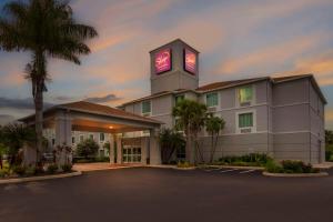 a hotel with a clock tower in a parking lot at Sleep Inn & Suites Port Charlotte-Punta Gorda in Port Charlotte