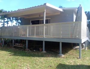 a house with a large deck on the grass at Hope Villa in Muri
