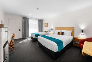 Postel nebo postele na pokoji v ubytování Econo Lodge Border Gateway Wodonga