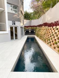 a swimming pool in the middle of a house at Simler at Sandton in Johannesburg