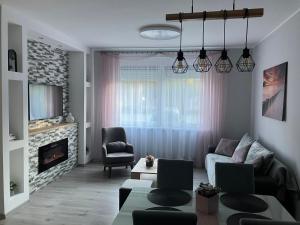 a living room with a couch and a fireplace at Villa Premium in Ada