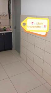 a kitchen with a sign on a tiled wall at Palas at Cameron Highland in Cameron Highlands