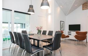 a dining room with a table and chairs at Gorgeous Home In Løkken With Sauna in Løkken