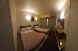 Postel nebo postele na pokoji v ubytování New Pola Hotel