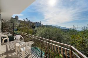 a balcony with two white chairs and a view at La Vista Sul Golfo in Massa Lubrense