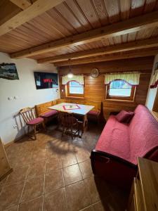 a living room with a couch and a table and chairs at Holiday house Pokrovec - Bohinj in Bohinj