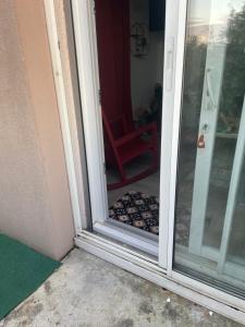 a glass door with a dog bed in front of it at Studio haut près de Toulouse à Castelginest in Castelginest