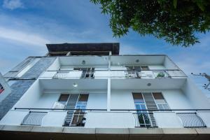 a white building with windows and a blue sky at Singhe Apartment in Galle