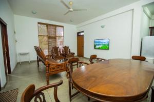 a dining room with a table and chairs at Singhe Apartment in Galle