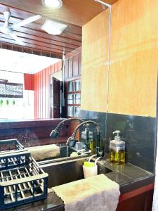 a kitchen with a sink and two faucets at Home in Tambon Hai Ya, 4 minutes walk to Old City by NNTH Home cnx in Chiang Mai