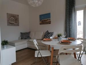 a living room with a white table and a white couch at Casa Bartelli - Ceriale in Ceriale
