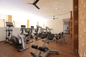 a gym with treadmills and elliptical machines at Cozy 3BR Asatti Apartment near ICE BSD By Travelio in Tangerang