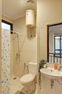 a bathroom with a toilet and a sink at Cozy 3BR Asatti Apartment near ICE BSD By Travelio in Tangerang