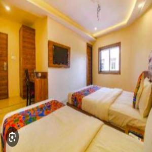 Postel nebo postele na pokoji v ubytování Hotel Elegant - Mohammed Ali Road