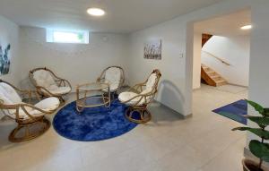 a room with three chairs and a blue rug at Lovely Home In Bolmsö With Sauna in Bolmsö +25 photos