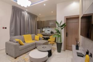 a living room with a couch and a table at One90 Apartment in Lagos
