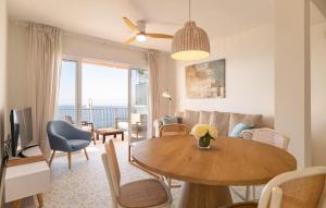 a living room with a table and a couch at Stunning Apartment In Almuñecar in Almuñécar