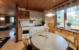 a kitchen with a table and a dining room at 2 Bedroom Stunning Home In Lönashult in Lönashult