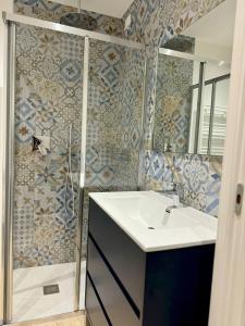 a bathroom with a sink and a shower at Appartamento Magritte in Brescia