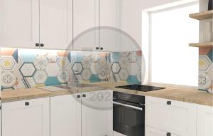 Una cocina con gabinetes blancos y una estufa. en Cozy Apartment In Starigrad Paklenica, en Starigrad-Paklenica