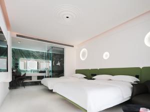 Voodi või voodid majutusasutuse 丽江熹v空中花园智能观景酒店 toas