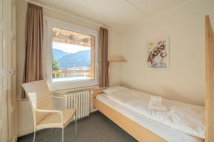 Postel nebo postele na pokoji v ubytování Sans Souci EG by Arosa Stay