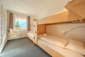 Postel nebo postele na pokoji v ubytování Sans Souci EG by Arosa Stay