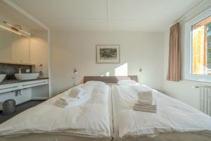 Postel nebo postele na pokoji v ubytování Sans Souci EG by Arosa Stay