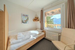 Postel nebo postele na pokoji v ubytování Sans Souci EG by Arosa Stay