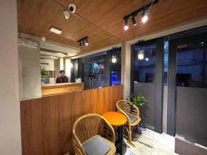 a restaurant with a table and chairs and a counter at Anex Hotel near Roxas Boulevard in Manila