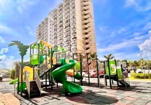 a playground with a slide in front of a building at Spacious Condo Unit with Balcony in Lo-oc