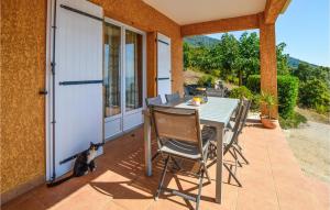 a cat sitting next to a table on a patio at Nice Home In Casalabriva With Wifi in Casalabriva