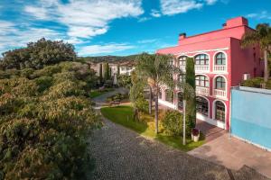 an aerial view of a pink building with trees at Hotel Blancafort Spa Termal in La Garriga