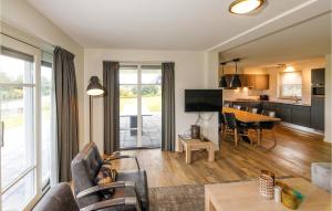 a living room with a couch and a table at Beulaker 8P in Giethoorn +12 photos