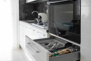 a kitchen with an open drawer in a oven at Leaf - ApartHotel 2 in Delia +5 photos