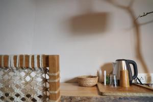 a counter with a coffee maker on a wooden table at Earthy room - THHPSOCIETY - THE HUMAN HAPPINESS PROJECT in Mukteswar +19 photos