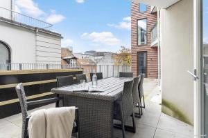 a table and chairs on the balcony of a house at Premium High-Street Home w Large Private Terrace in Aarhus