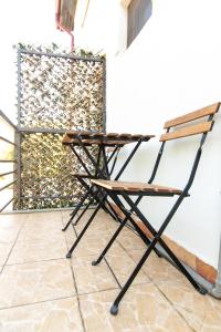 a wooden chair sitting next to a wall at AlmaVille Mamaia in Mamaia Sat/Năvodari