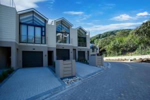 a house on a street with a driveway at Wild Sage - Wilderness Cottage in Wilderness