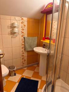 a small bathroom with a sink and a toilet at Pensiunea Victoria in Râşnov +81 photos