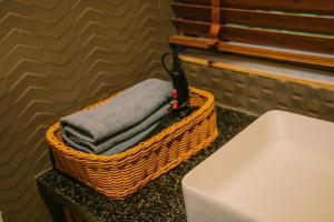 a basket of towels sitting on a counter next to a toilet at Anna Little Garden - Fish House in Sóc Sơn +33 photos