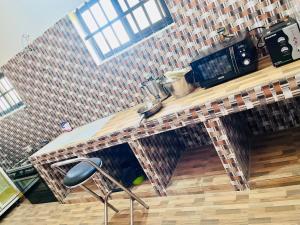 a kitchen with a counter with a sink at Les Résidences Terre Royale in Sokouhoué