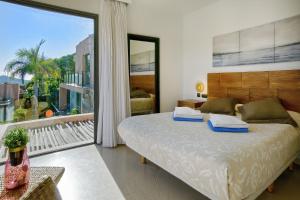 a bedroom with a large bed and a large window at Holiday Home Villa Gema in Maspalomas +23 photos